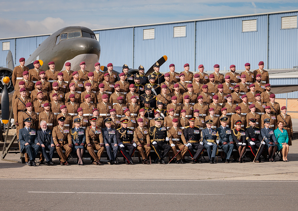 A group image of 47 Air Despatch Squadron soldiers and dignitaries in front of the Squadron gate guardian (a C-47 Dakota aircraft) and Squadron buildings in the background.